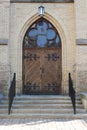 Large Wooden Door At The Top Of Stone Steps Leading To Entrance Of A Church