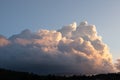 Large dramatic cloud formation at sunset in front of blue skies