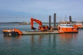 Large Dredging Vessel with Excavator Working in Harbor. Royalty Free Stock Photo