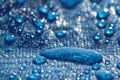 Large drops and splashes of water after rain lie on a blue tarpaulin Royalty Free Stock Photo