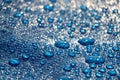 Large drops and splashes of water after rain lie on a blue tarpaulin Royalty Free Stock Photo