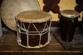 A large drum made of wood and leather,tied with twine. A small drum made of Buffalo leather and mahogany. National musical instrum