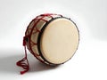 A large drum with red strings hanging from it Royalty Free Stock Photo