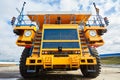 A large dump truck. Yellow dump truck controlled by a robot on the work site. Mining equipment for transporting coal with open-pit