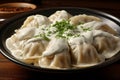 Large dumplings with sour cream and dill with herbs in a plate