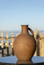 Large earthenware jug stands on a table on the shore near the sea water in Batumi, Georgia Royalty Free Stock Photo