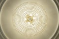 Large electric chandelier made of glass beads on a white decorative ceiling decorated with stucco molding Royalty Free Stock Photo