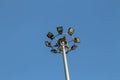 A large electric pole filled with spotlights in the blue sky Royalty Free Stock Photo