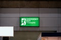 Large Emergency exit sign green light box is placed on the wall of exhibition hall. Thai Letter is Thai Language on the green Royalty Free Stock Photo