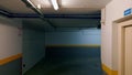 Large empty building hallway with closed doors gates illuminated led lamps.