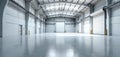 Large empty industrial warehouse interior with polished concrete floor, high ceiling. White roller shutter doors visible Royalty Free Stock Photo