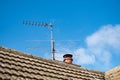 Large, english cottage style brick chimney showing a newly installed terracotta pot. Royalty Free Stock Photo