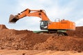 Large excavator loads rock with iron or bauxite mining