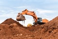 Large excavator loads rock with iron or bauxite mining