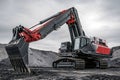 Large excavator working on coal mine site under cloudy sky Royalty Free Stock Photo