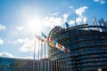 Large facade European PArliament building in Strasbourg with all EU member Flags