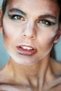 Large-face portrait.Interesting makeup with paint strokes. Look interrogative, with a squint