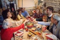 Large family clinking glasses on Christmas dinner