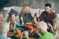 Large family gathering on thanksgiving day sit table enjoy october meal hold hands pray meeting mature relatives small