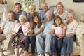 Large Family Group Sitting On Sofa Indoors Royalty Free Stock Photo