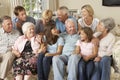 Large Family Group Sitting On Sofa Indoors Royalty Free Stock Photo