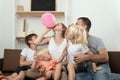 Large family at home preparing for the holiday and inflating balloon Royalty Free Stock Photo