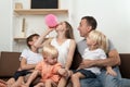 Large family at home preparing for the holiday. Mother inflating balloon, surprise dad Royalty Free Stock Photo