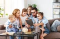 Large family mother, father and children with tablet computer at home Royalty Free Stock Photo
