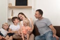 Large family mother father, two sons and little daughter are chatting on couch. Family leisure Royalty Free Stock Photo