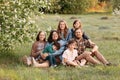Large family smiles together in sunny field Royalty Free Stock Photo