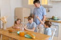 Large family with teenage children eating breakfast in kitchen. Caucasian Royalty Free Stock Photo