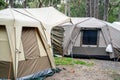 Large family tents on a campsite campground. Group camping vacation. Family camping Royalty Free Stock Photo