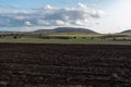 Large farmland hills green blue sky cloudy autumn agriculture farm land landscape clean sharp rural scene Royalty Free Stock Photo