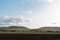 Large farmland hills green blue sky cloudy autumn agriculture farm land landscape clean sharp rural scene Royalty Free Stock Photo