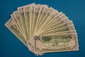 Large Fat Money Roll Isolated on a blue Background Royalty Free Stock Photo