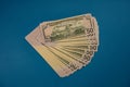 Large Fat Money Roll Isolated on a blue Background Royalty Free Stock Photo