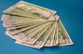 Large Fat Money Roll Isolated on a blue Background Royalty Free Stock Photo