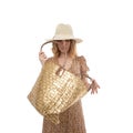 Large female bag of gold color in the hands of a woman in a brown dress isolated on a white background Royalty Free Stock Photo