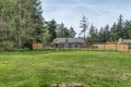 Large fenced in back yard green grass blue sky Royalty Free Stock Photo