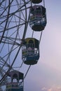 a large ferris wheel that is in the sky with two children inside