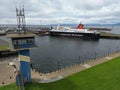 Large ferry boat traversing a harbor on a cloudy day in Ardrossan Marina, Scotland