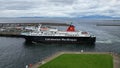 Large ferry boat traversing a harbor on a cloudy day in Ardrossan Marina, Scotland