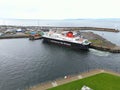 Large ferry boat traversing a harbor on a cloudy day in Ardrossan Marina, Scotland