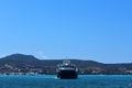 A large ferry sails over a beautiful blue sea.