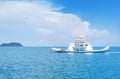 Large ferryboat carrying passengers and cars crossing in blue sea between Koh Chang island and Trad province, Thailand Royalty Free Stock Photo