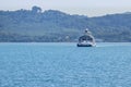 Large ferryboat carrying passengers and cars crossing in blue sea between Samui island and Surat Thani province, Thailand