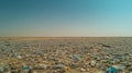 A large field of plastic bottles and other trash
