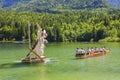 Large figures of Narcissus that grow in Alpine meadows, swim in the lake. Festival Narzissenfest