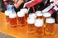 Large filled beer mugs on a table