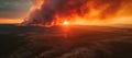 A large fire is seen from a distance as the sun sets, AI